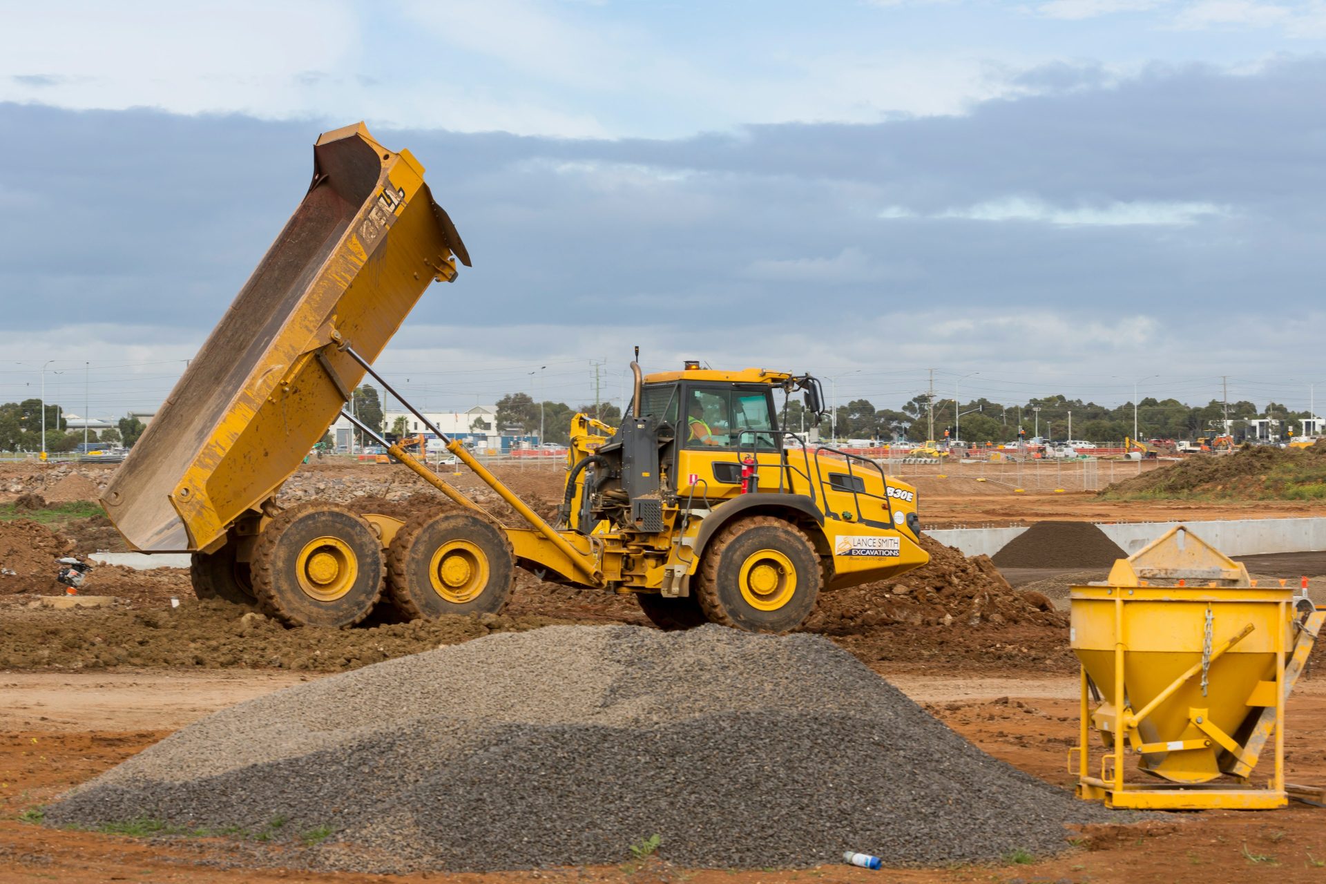 yellow and black heavy equipment on brown dirt field during daytime